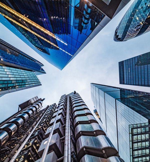 Looking up at tall glass buildings in the City.